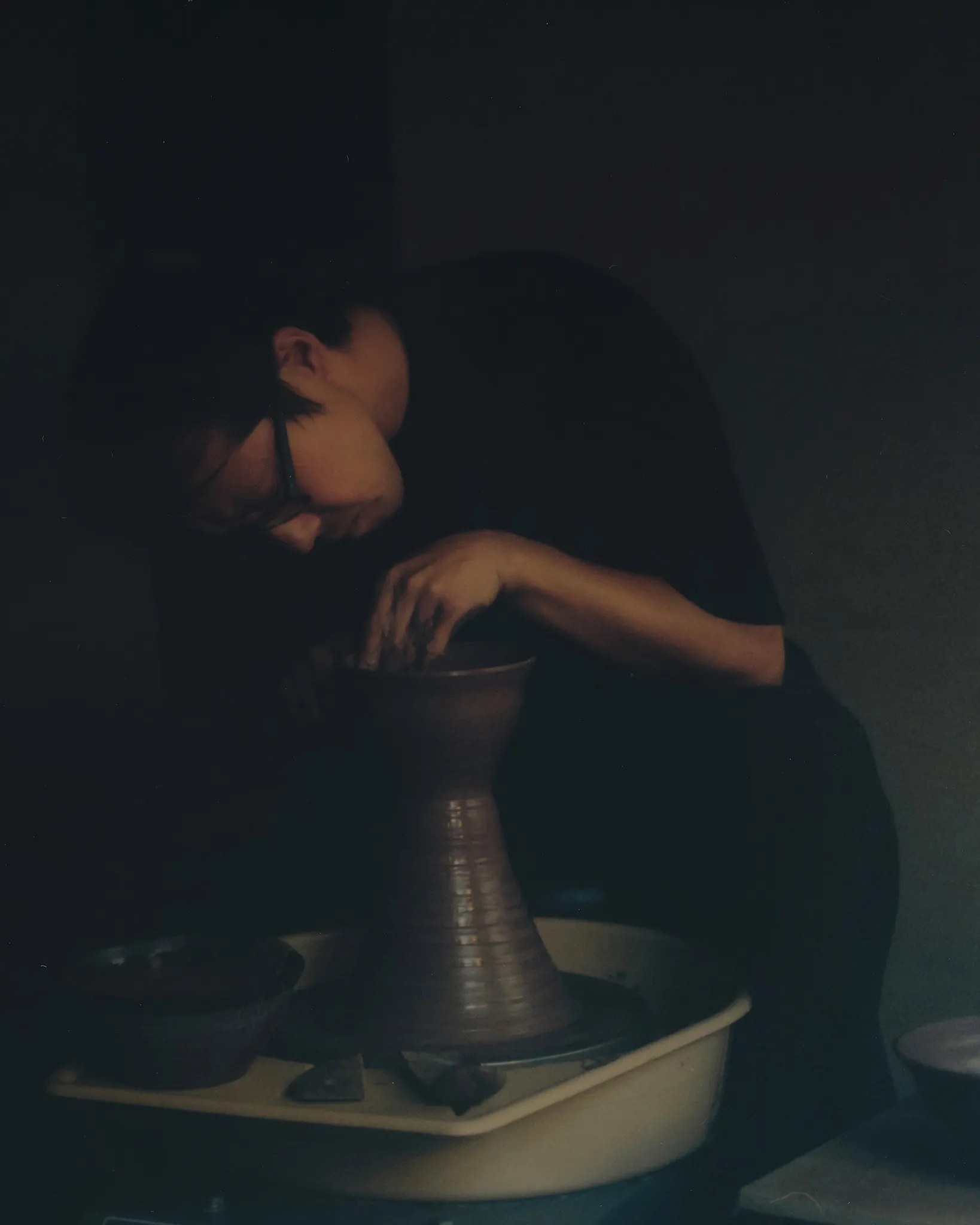 Tōsei bent over the pottery wheel, and a portrait of Huh Namhoon