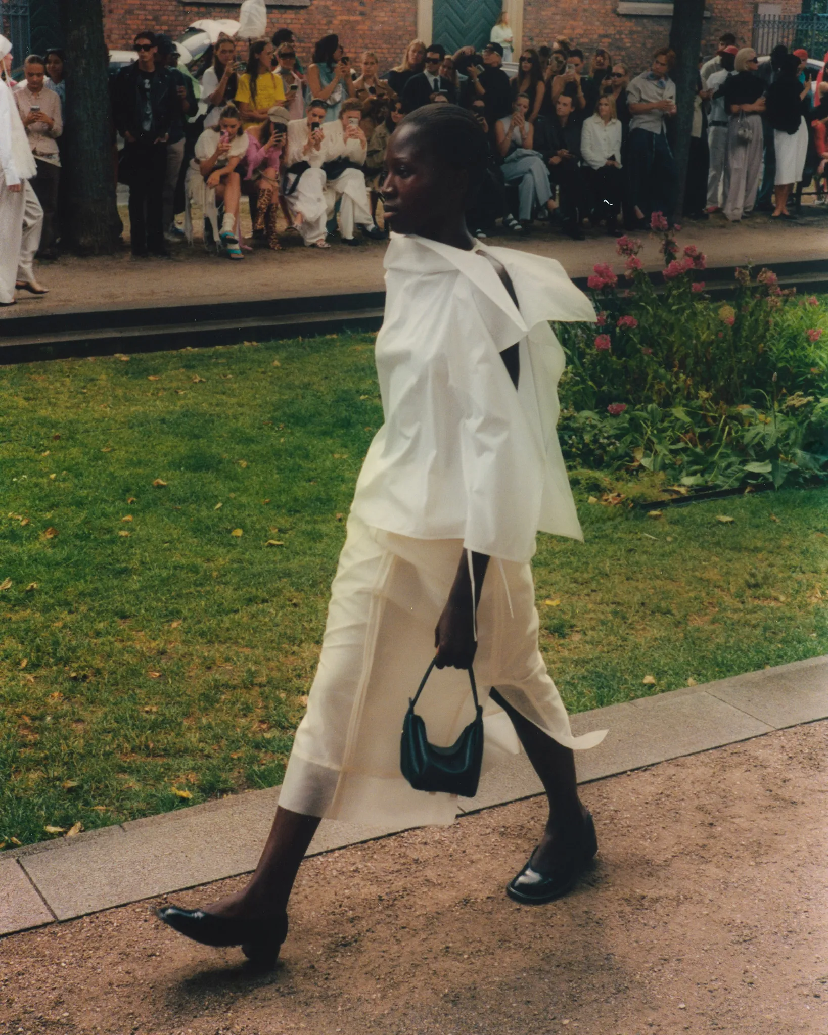 MKDT Studio SS27 runway looks – black knit and layered white separates