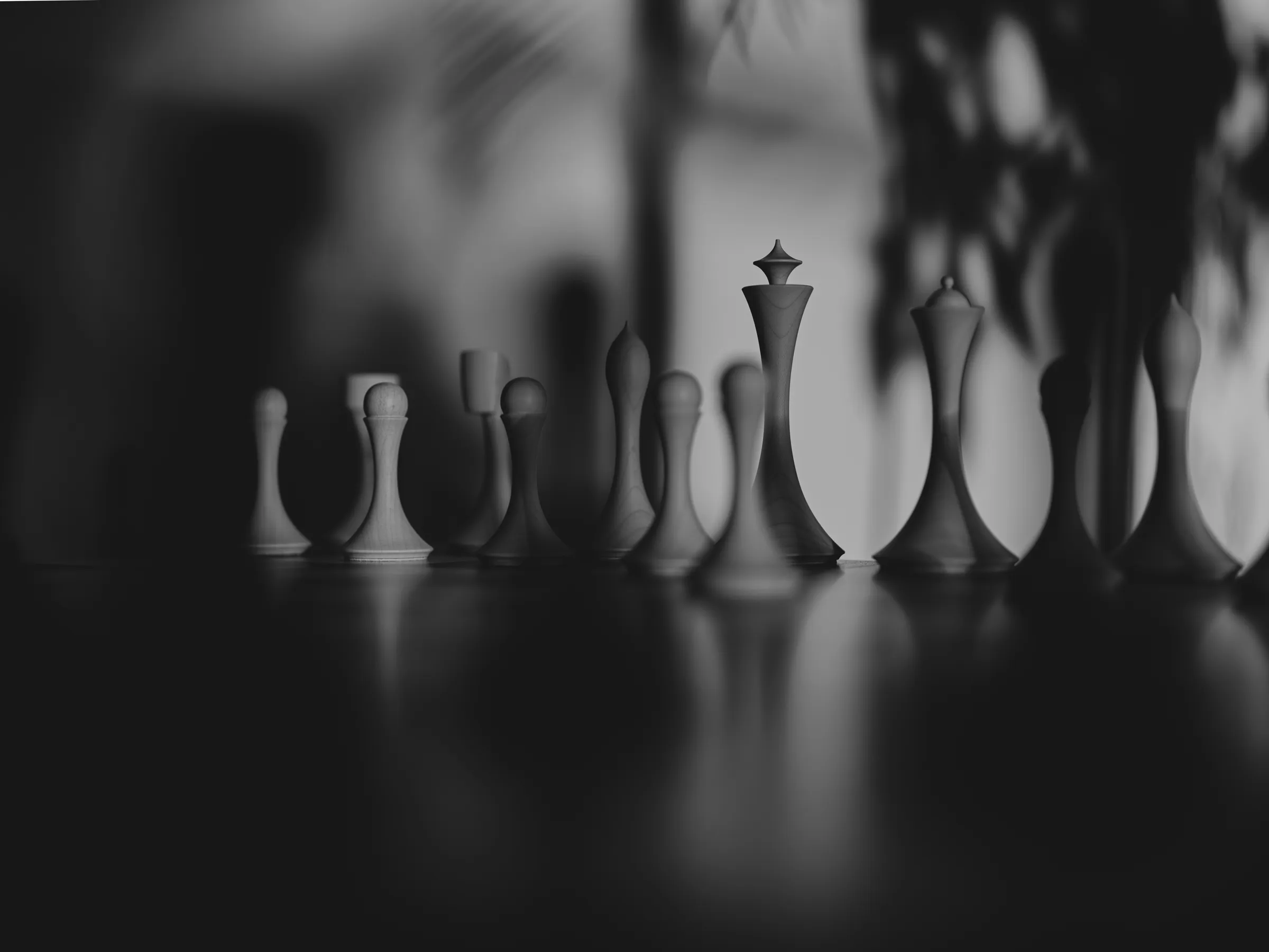 Chess pieces lined up in monochrome, the knight reduced to a single gesture, Hasselblad X2D II 100C