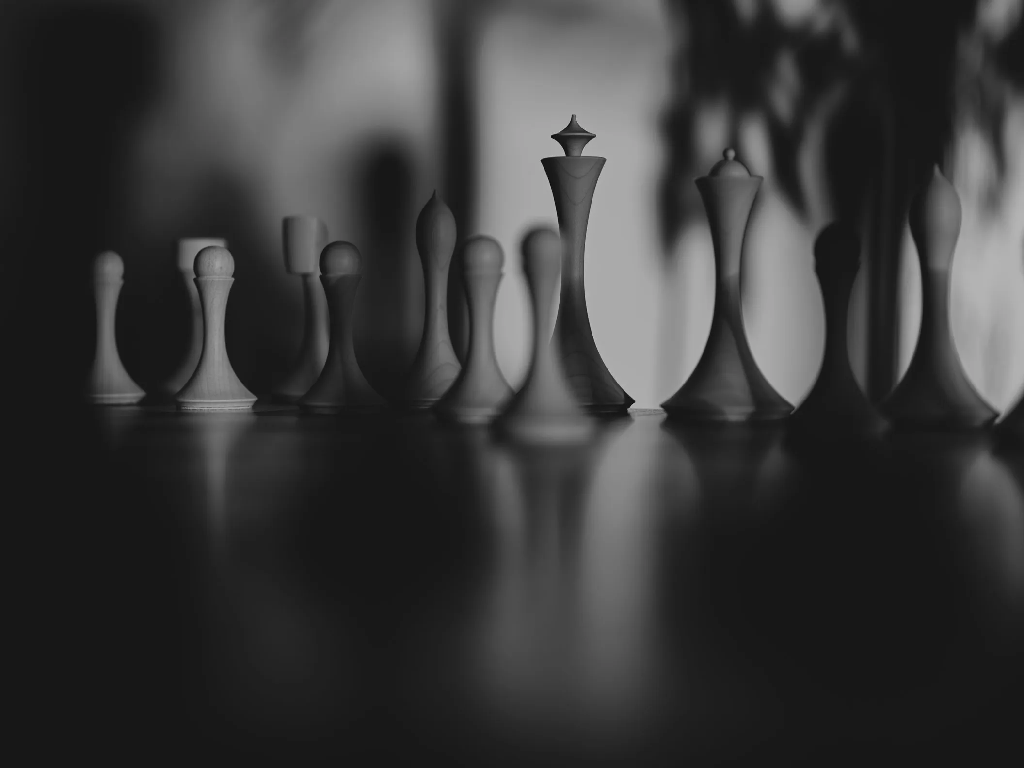 Chess pieces lined up in monochrome, the knight reduced to a single gesture, Hasselblad X2D II 100C