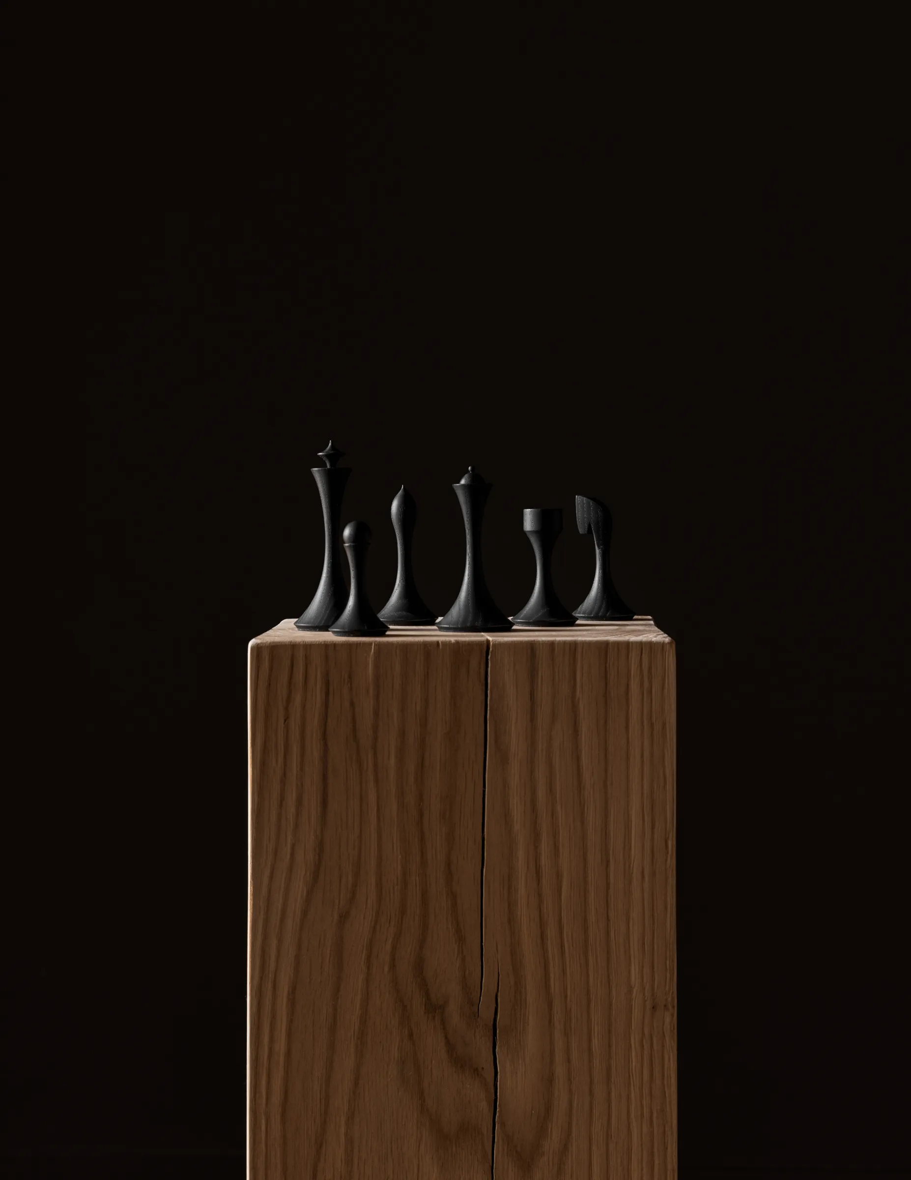 Turned chess pieces standing on raw wooden blanks straight from the lathe, medium format digital capture