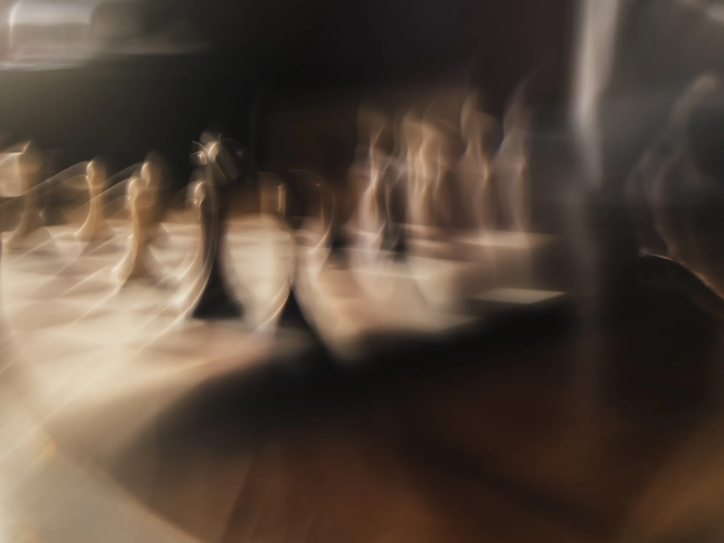 Chess pieces dissolving into motion blur in warm light, medium format digital capture, Hasselblad X2D II 100C